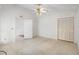 Well-lit bedroom with tile floors, ceiling fan, and a closet for ample storage at 9064 Sw 91St Cir, Ocala, FL 34481