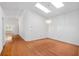 Spacious living room with hardwood floors, skylights, and a contemporary chandelier at 9064 Sw 91St Cir, Ocala, FL 34481