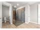 Modern bathroom features a glass-enclosed shower, wood-look tile floors, and neutral paint at 9085 Sw 89Th Loop, Ocala, FL 34481