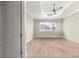 Bedroom with neutral paint, hardwood floors, and a window with natural light, offering a calm and inviting atmosphere at 9085 Sw 89Th Loop, Ocala, FL 34481