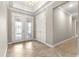 Welcoming foyer with elegant tile flooring, a tray ceiling, and decorative glass double doors at 9085 Sw 89Th Loop, Ocala, FL 34481