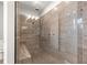 Luxurious walk-in shower featuring designer tile, a built-in bench, and modern fixtures at 9085 Sw 89Th Loop, Ocala, FL 34481