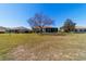 Well-maintained backyard featuring brick paver patio, shade trees, and an enclosed porch at 9167 Sw 99Th Court Rd, Ocala, FL 34481