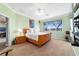 Bedroom featuring carpeted floors, ceiling fan, large window, and a walk-in closet at 9167 Sw 99Th Court Rd, Ocala, FL 34481