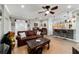 Inviting living area featuring wood floors, a comfortable sofa, and a kitchen view at 9167 Sw 99Th Court Rd, Ocala, FL 34481