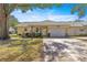 Charming single-story home featuring a large driveway, attached garage, and well-maintained landscaping at 9335 Sw 85Th Ter # A, Ocala, FL 34481