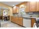 Kitchen displaying stainless steel appliances, wood cabinets, and views into dining area at 9335 Sw 85Th Ter # A, Ocala, FL 34481