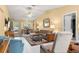 Bright living room featuring neutral walls, vaulted ceiling, ceiling fan, and comfortable seating arrangement at 9335 Sw 85Th Ter # A, Ocala, FL 34481