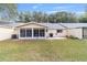 Backyard view showcasing a screened-in lanai, patio, and well-manicured lawn at 9348 Sw 82Nd Ter # C, Ocala, FL 34481