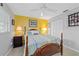 Bedroom with a four-poster bed, yellow wallpaper, and a double door closet at 9348 Sw 82Nd Ter # C, Ocala, FL 34481