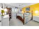 Bedroom with yellow accent wall, a four-poster bed, and a ceiling fan at 9348 Sw 82Nd Ter # C, Ocala, FL 34481