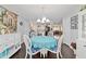 Bright dining room featuring a blue tablecloth and views into the living room and kitchen at 9348 Sw 82Nd Ter # C, Ocala, FL 34481