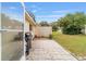 Outdoor patio area with gray tiling, grill and a lattice screen for backyard privacy at 9348 Sw 82Nd Ter # C, Ocala, FL 34481