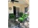 Outdoor seating includes three chairs with green botanical cushions around glass-topped table at 9535 Sw 85Th Ter # C, Ocala, FL 34481