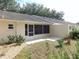 Home exterior featuring a screened-in patio and well-maintained yard with manicured landscaping and gravel at 9652 Sw 84Th Ter # C, Ocala, FL 34481