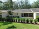 Beautiful backyard featuring a well-maintained lawn, lush landscaping, and a screened lanai for outdoor enjoyment at 9652 Sw 84Th Ter # C, Ocala, FL 34481
