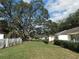 Large grassy backyard with mature trees, white fencing, and manicured landscaping, providing a peaceful view at 9652 Sw 84Th Ter # C, Ocala, FL 34481