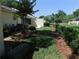 The backyard has a well-manicured lawn and established landscaping including mulch beds, bushes, and mature shade trees at 9652 Sw 84Th Ter # C, Ocala, FL 34481