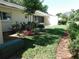 Well-maintained backyard featuring healthy green grass and a decorative landscape at 9652 Sw 84Th Ter # C, Ocala, FL 34481
