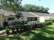 This property boasts a well-manicured backyard with lush landscaping, including hedges, bushes, and mature trees at 9652 Sw 84Th Ter # C, Ocala, FL 34481