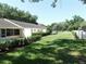 Well-maintained backyard featuring healthy green grass, patio and decorative landscape at 9652 Sw 84Th Ter # C, Ocala, FL 34481