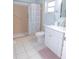 Bathroom featuring a pink-tiled shower, white vanity, and ample natural light at 9652 Sw 84Th Ter # C, Ocala, FL 34481