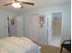 Bedroom showcasing a neutral carpet, white closet doors and ensuite bath at 9652 Sw 84Th Ter # C, Ocala, FL 34481