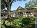 A well-maintained one-story villa featuring attached garages, a cozy front porch, and a lush green lawn with mature trees at 9652 Sw 84Th Ter # C, Ocala, FL 34481