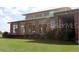 Stately building with large windows, surrounded by a lush green lawn at 9652 Sw 84Th Ter # C, Ocala, FL 34481