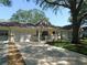 Inviting one-story villa with a well-kept lawn, driveway, attached garage, and charming front porch with blue rocking chairs at 9652 Sw 84Th Ter # C, Ocala, FL 34481
