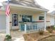 Inviting front porch with patriotic flag and rocking chairs at 9652 Sw 84Th Ter # C, Ocala, FL 34481