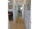 Hallway with wood floors, connecting to rooms with neutral paint and bright light at 9652 Sw 84Th Ter # C, Ocala, FL 34481