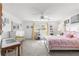 Light-filled bedroom with a ceiling fan, a light-colored wood bed frame, and soft natural light at 9866 Sw 97Th Ln, Ocala, FL 34481