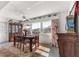 Bright dining room with a wooden table, floral curtains, and natural light through the windows at 9866 Sw 97Th Ln, Ocala, FL 34481