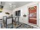 Inviting front porch with brick walls, ceiling fan, and a cozy seating area with a colorful rug at 9866 Sw 97Th Ln, Ocala, FL 34481