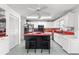 Well-lit kitchen with a center island, white cabinetry, and modern appliances at 9866 Sw 97Th Ln, Ocala, FL 34481