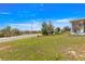 Expansive front yard featuring lush green grass, mature trees, and views of the surrounding neighborhood at 9866 Sw 97Th Ln, Ocala, FL 34481