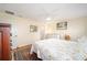 Bedroom featuring a patterned rug, floral bedspread, and natural lighting at 9983 Sw 90Th Loop, Ocala, FL 34481