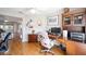 Bright home office featuring wood floors, built-in shelves, and a desk with ample workspace at 9983 Sw 90Th Loop, Ocala, FL 34481