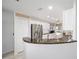 Well-lit kitchen featuring granite counters, stainless steel appliances, and white cabinets at 9983 Sw 90Th Loop, Ocala, FL 34481