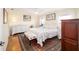 Bedroom featuring a patterned rug, floral bedspread, and natural lighting at 9983 Sw 90Th Loop, Ocala, FL 34481