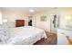 Spacious main bedroom featuring a patterned rug, floral bedspread, and natural lighting at 9983 Sw 90Th Loop, Ocala, FL 34481