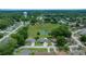 Aerial view of the neighborhood featuring mature trees, well-kept homes and landscaping, and a pond at 10821 Sw 87Th Ter, Ocala, FL 34481