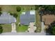 Overhead view featuring a home with a gray roof, a driveway, and manicured landscaping on a sunny day at 10821 Sw 87Th Ter, Ocala, FL 34481