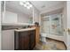 Well-lit bathroom featuring a dark wood vanity with a granite countertop and a shower with a glass door at 10821 Sw 87Th Ter, Ocala, FL 34481