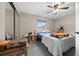 Cozy bedroom with neutral walls, ceiling fan, carpet, and a window letting in natural light at 10821 Sw 87Th Ter, Ocala, FL 34481