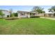 Well-manicured lawn enhances this charming single-story home with tidy landscaping at 10821 Sw 87Th Ter, Ocala, FL 34481