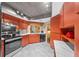 Well-lit kitchen features stainless steel appliances, orange cabinetry, and marble countertops at 10821 Sw 87Th Ter, Ocala, FL 34481