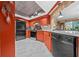 Well-lit kitchen features stainless steel appliances, orange cabinetry, and marble countertops at 10821 Sw 87Th Ter, Ocala, FL 34481