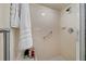 Shower stall with white tile, grab bar, and shampoo bottles on a small shelf at 10821 Sw 87Th Ter, Ocala, FL 34481